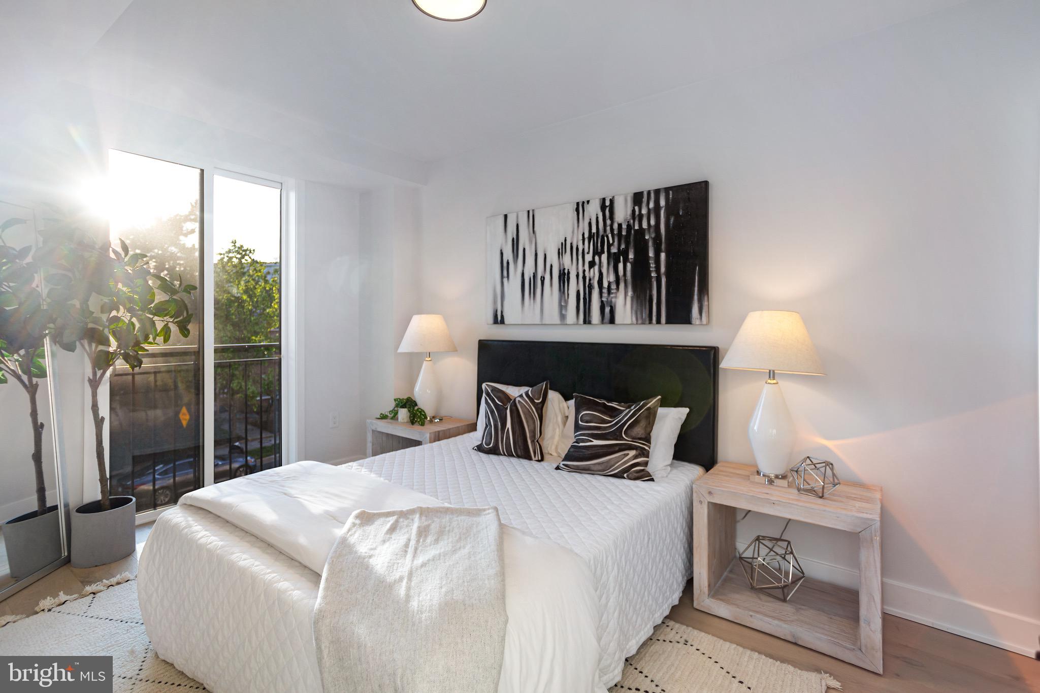 845 19th Street Northeast, Unit PH10 Washington, DC 20002 - Photo 11 of 22 a bedroom with a bed and wooden floor