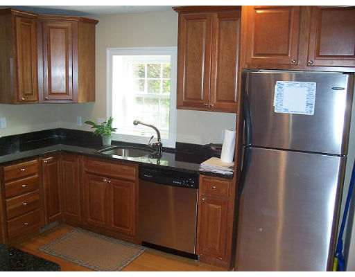 31 Harding Road Lexington, MA 02420 - Photo 7 of 16 a kitchen with stainless steel appliances granite countertop a refrigerator and a sink