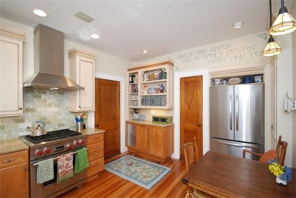 51 Winthrop Road, Unit 2 Brookline, MA 02445 - Photo 13 of 20 a kitchen with stainless steel appliances granite countertop a stove a refrigerator and a wooden cabinets