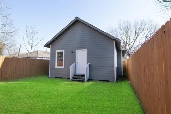 a view of front of house with a garden