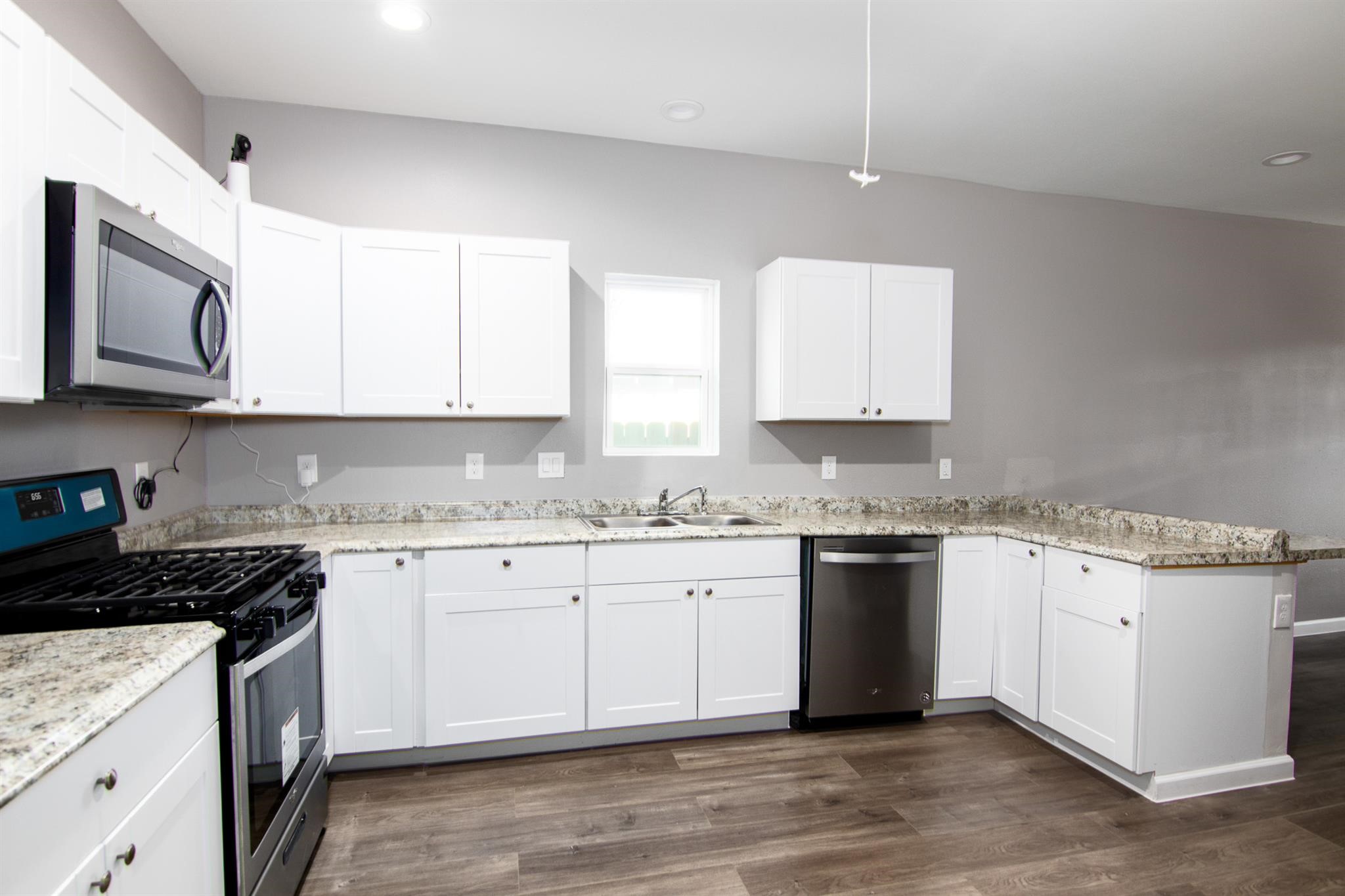1709 Stevens Street Houston, TX 77026 - Photo 5 of 17 a kitchen with granite countertop cabinets stainless steel appliances and a sink