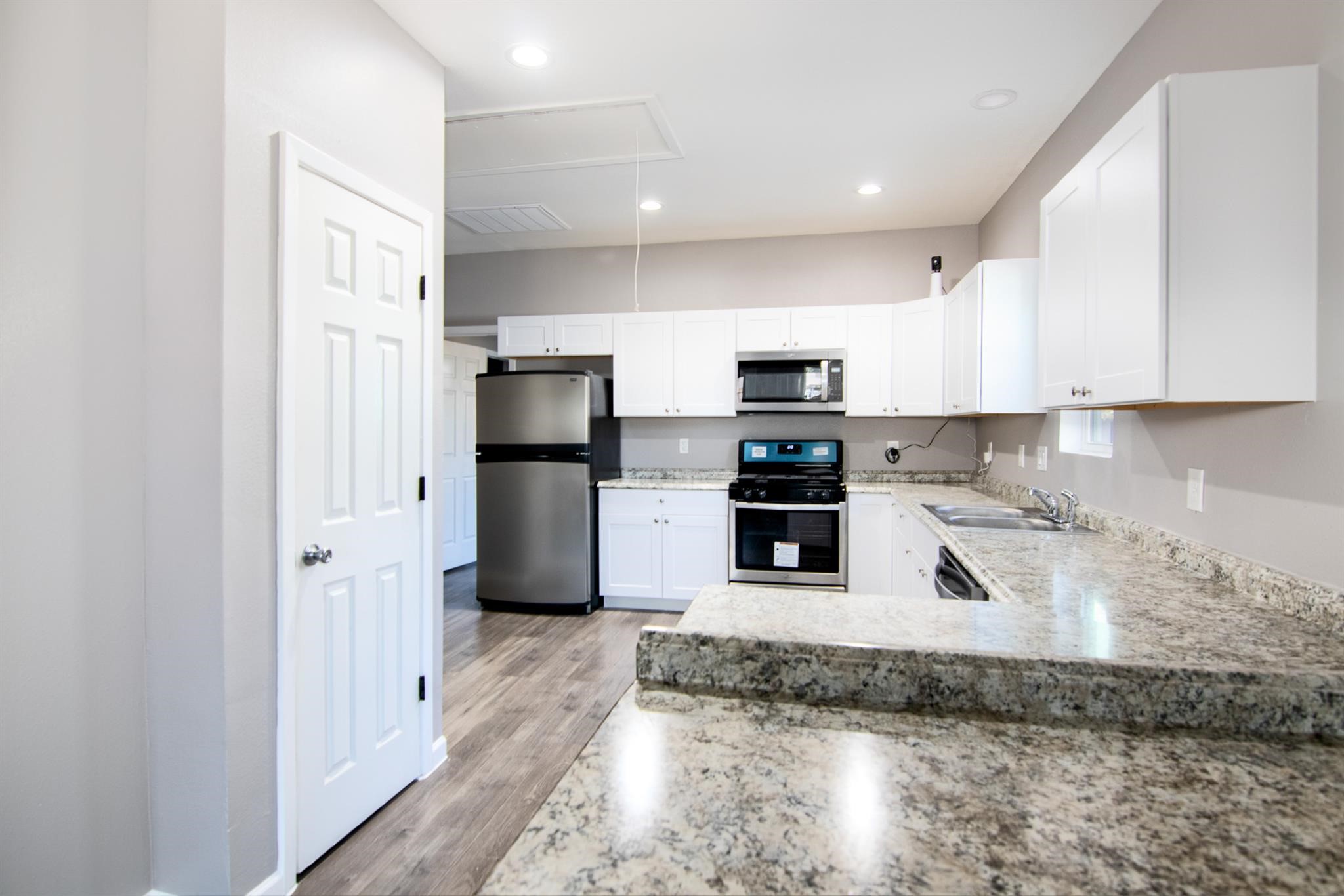 1709 Stevens Street Houston, TX 77026 - Photo 6 of 17 a kitchen with stainless steel appliances granite countertop a refrigerator a stove and a sink