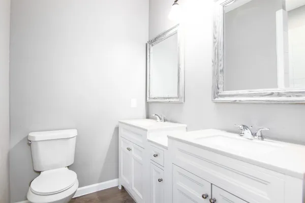 a bathroom with a toilet sink and mirror