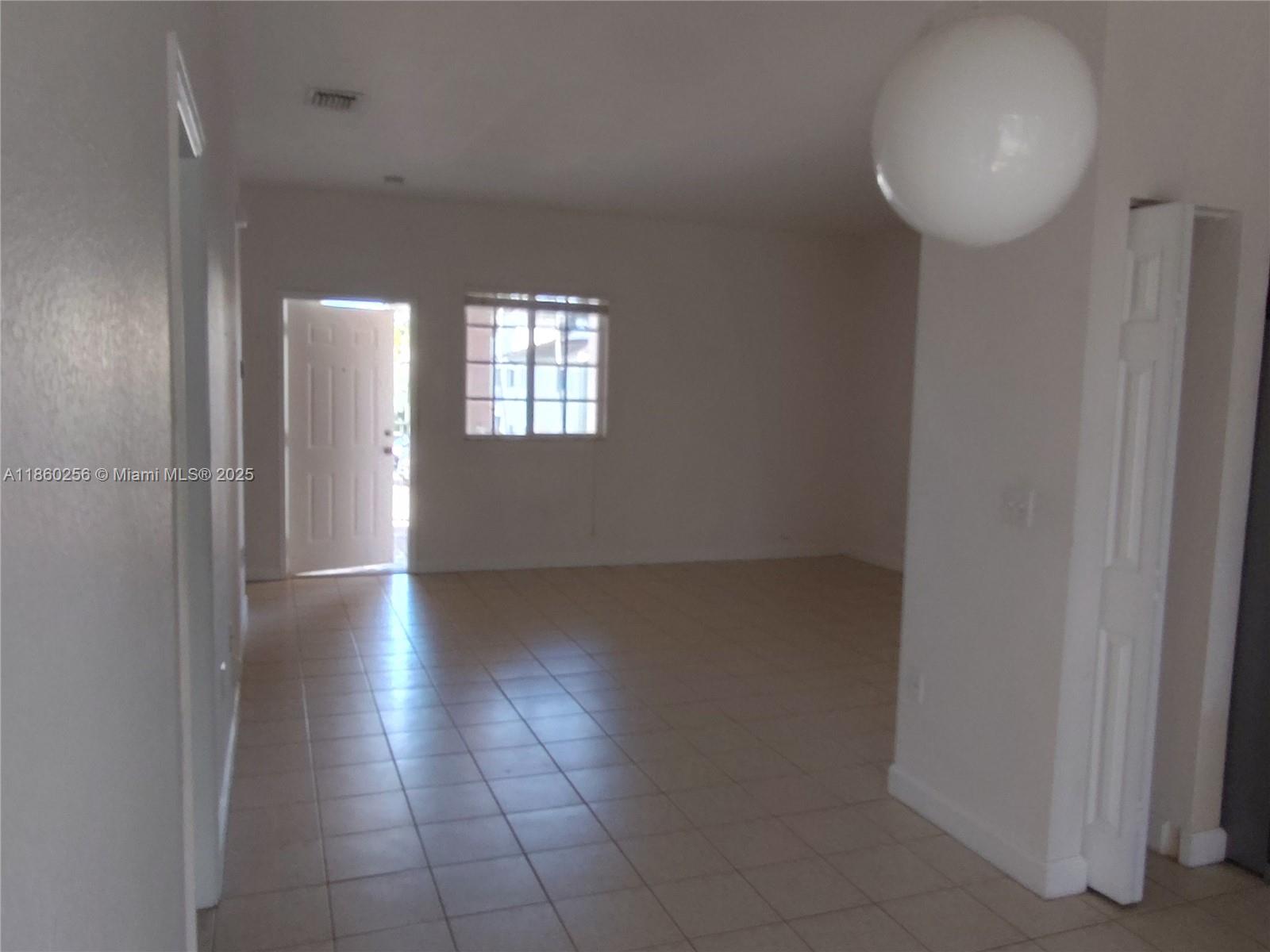Oasis Homestead, FL 33033 - Photo 3 of 9 a view of a livingroom with wooden floor and a window