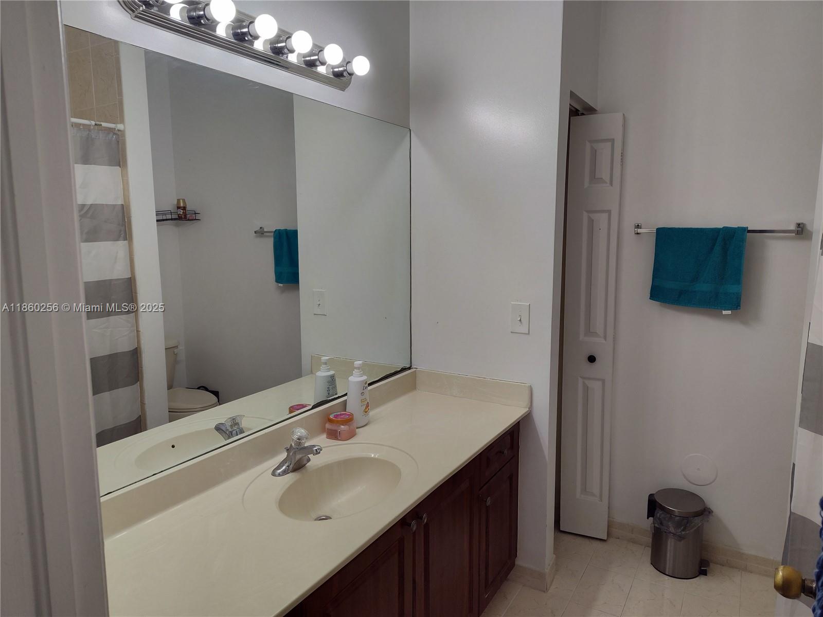 Oasis Homestead, FL 33033 - Photo 6 of 9 a bathroom with a sink double vanity and a mirror