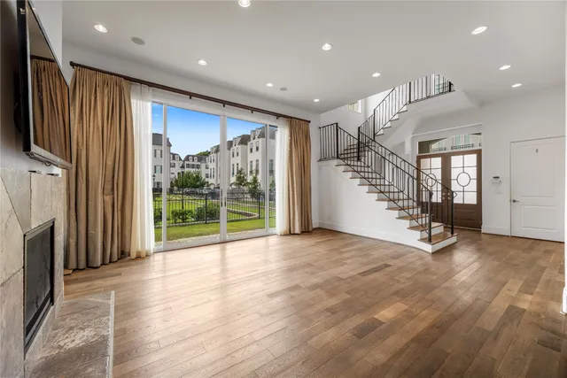 a view of an empty room with stairs and a fireplace