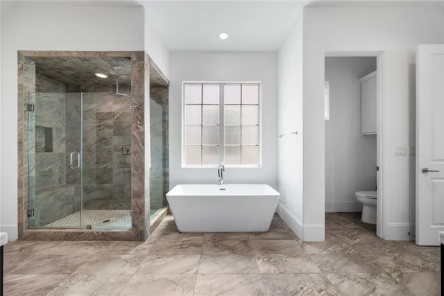 a spacious bathroom with a bathtub and toilet
