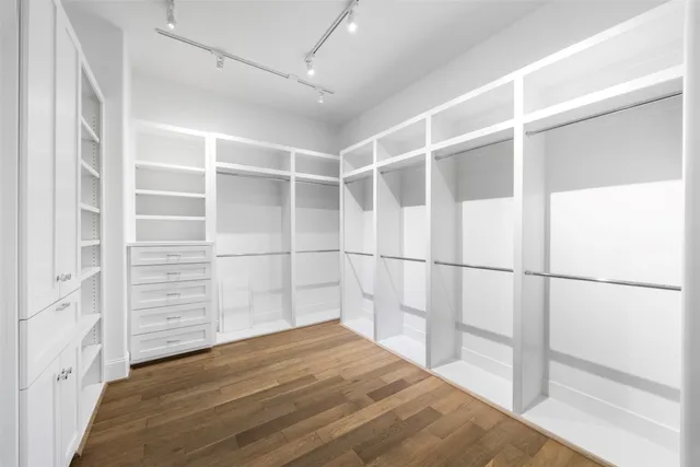 a view of a room with wooden floor and white walls