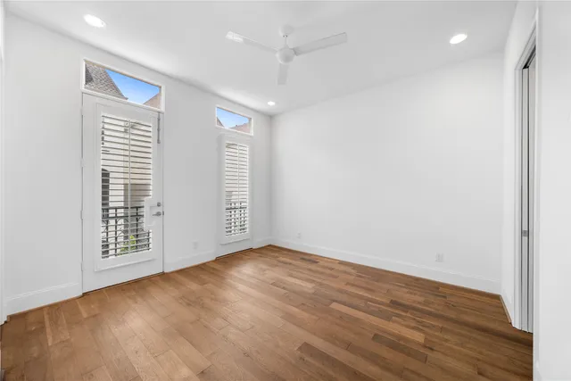 wooden floor in an empty room with a window