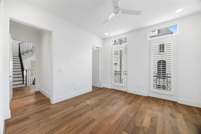 wooden floor in an empty room with a window