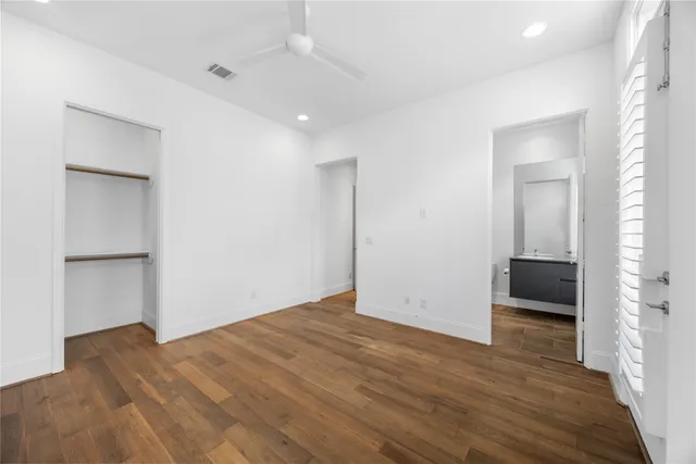 a bathroom with a bathtub shower sink mirror and toilet