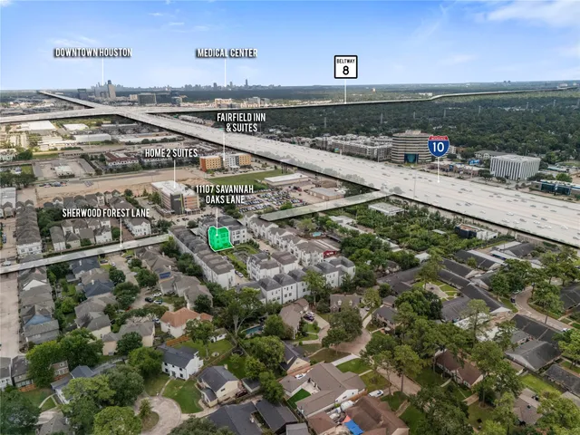 a view of a building with a garden and pathway