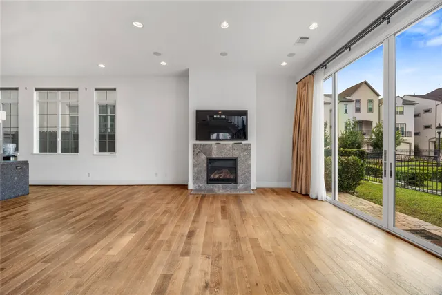 a view of a living room with a fireplace and floors