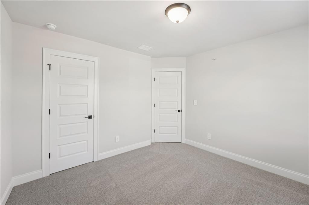 6440 Pinin Place Cumming, GA 30041 - Photo 33 of 52 an empty room with closet area
