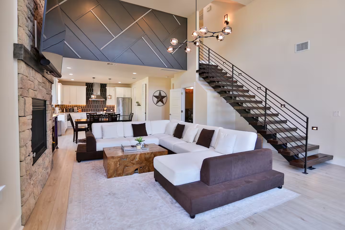 2203 Thornton Road, Unit A Austin, TX 78704 - Photo 5 of 22 Living area featuring a high ceiling, light wood finished floors, and a stone fireplace