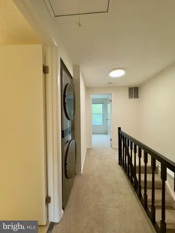 a view of hallway with washer and dryer