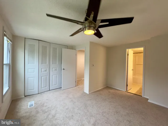 a view of empty room with ceiling fan
