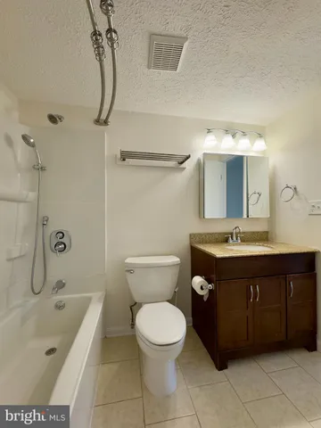 a spacious bathroom with a toilet sink and mirror