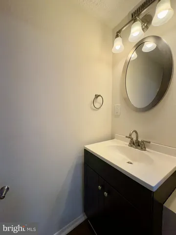 a bathroom with a sink mirror and vanity