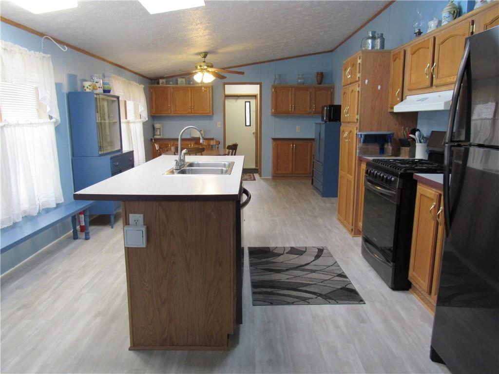 719 Joy Lane Butler, PA 16001 - Photo 14 of 36 a kitchen with kitchen island a sink stove and refrigerator
