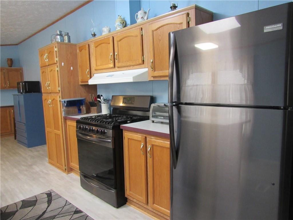 719 Joy Lane Butler, PA 16001 - Photo 15 of 36 a kitchen with a refrigerator and a stove