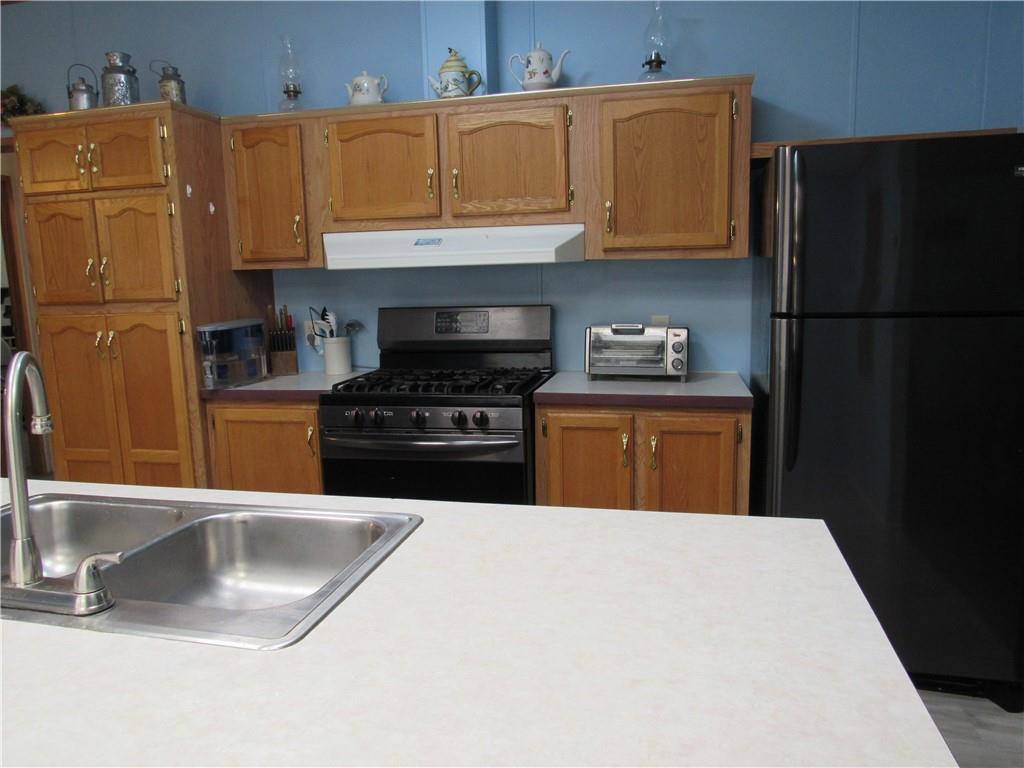 719 Joy Lane Butler, PA 16001 - Photo 16 of 36 a kitchen with a sink a stove and a refrigerator