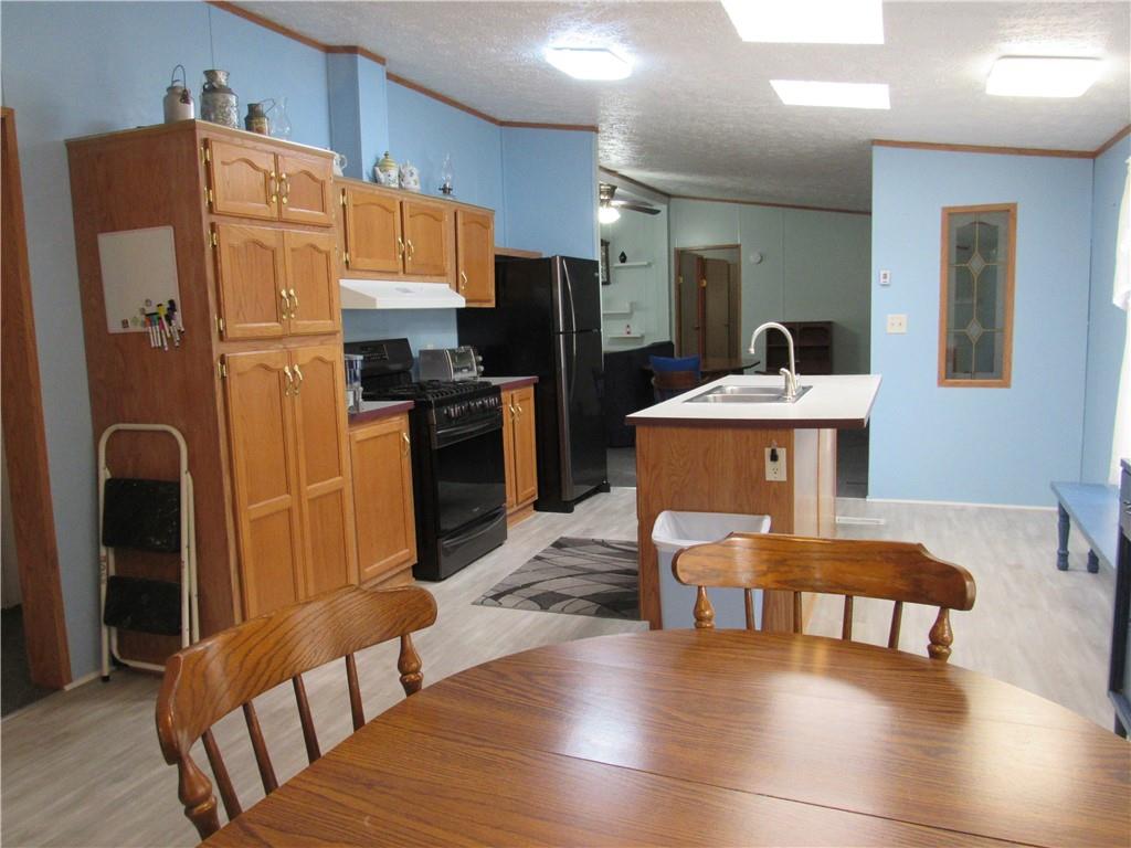719 Joy Lane Butler, PA 16001 - Photo 19 of 36 a kitchen with stainless steel appliances refrigerator stove microwave and furniture