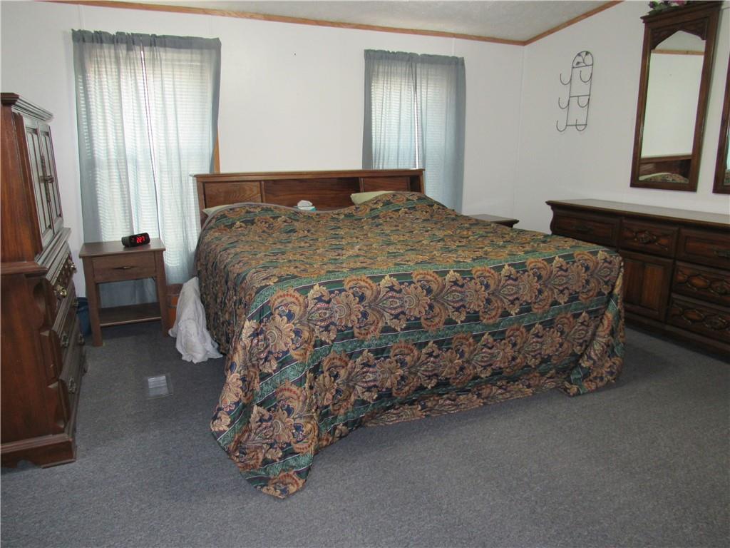 719 Joy Lane Butler, PA 16001 - Photo 24 of 36 a bed sitting in a bedroom next to a window