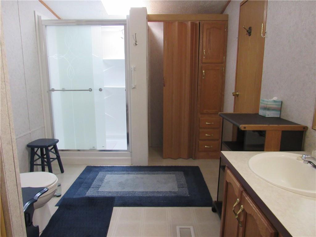 719 Joy Lane Butler, PA 16001 - Photo 27 of 36 a bathroom with a sink and a mirror
