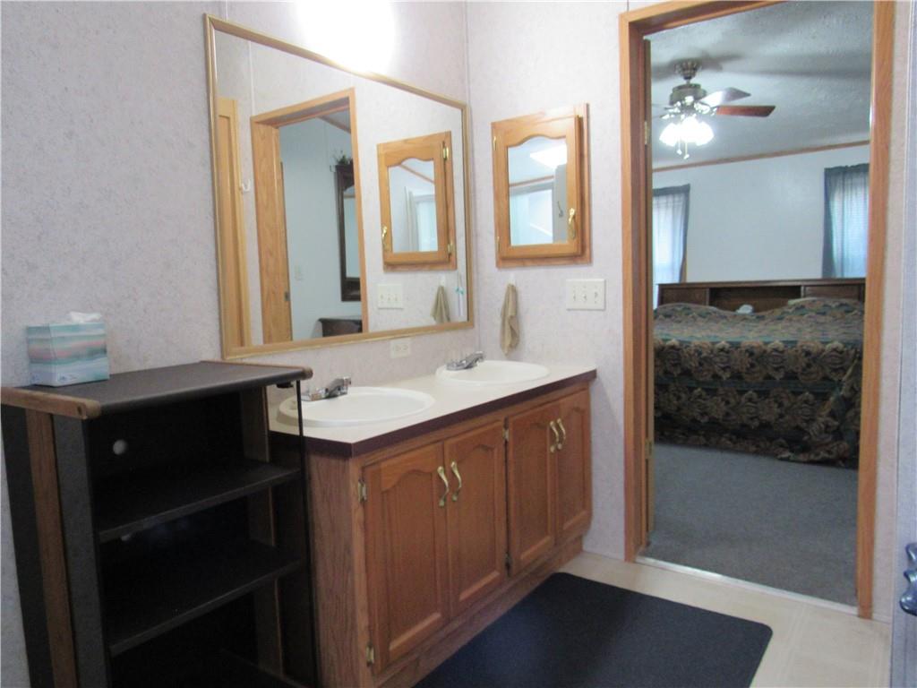 719 Joy Lane Butler, PA 16001 - Photo 30 of 36 a bathroom with a sink and a mirror