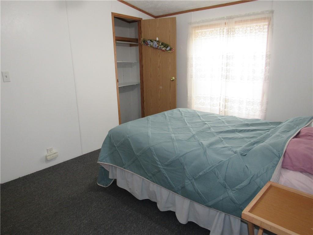 719 Joy Lane Butler, PA 16001 - Photo 32 of 36 a bed sitting in a bedroom next to a window