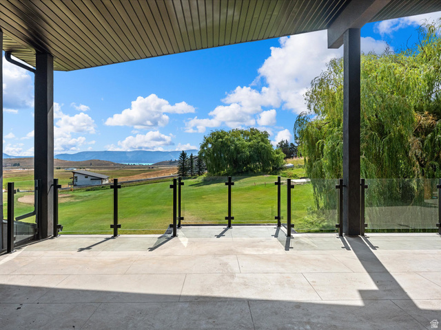 2610 Foxridge Road Garden City, UT 84028 - Photo 49 of 71 Expansive outdoor patio with glass railing and durable stone-finish flooring