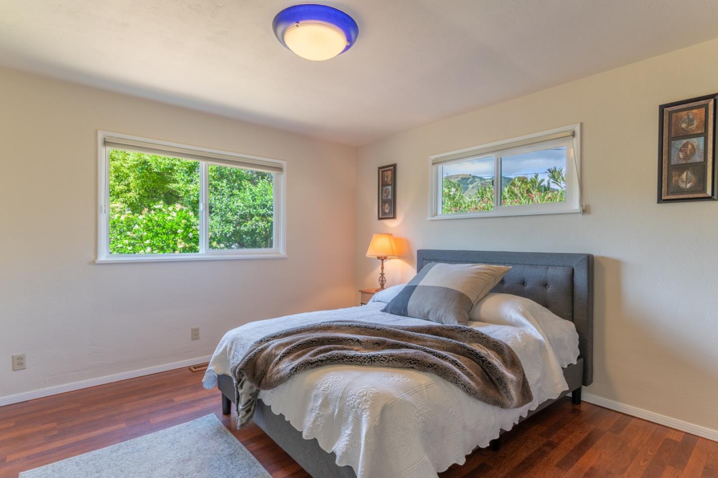 2 Merrill Way Carmel Valley, CA 93924 - Photo 20 of 43 a bed sitting in a bedroom next to a window
