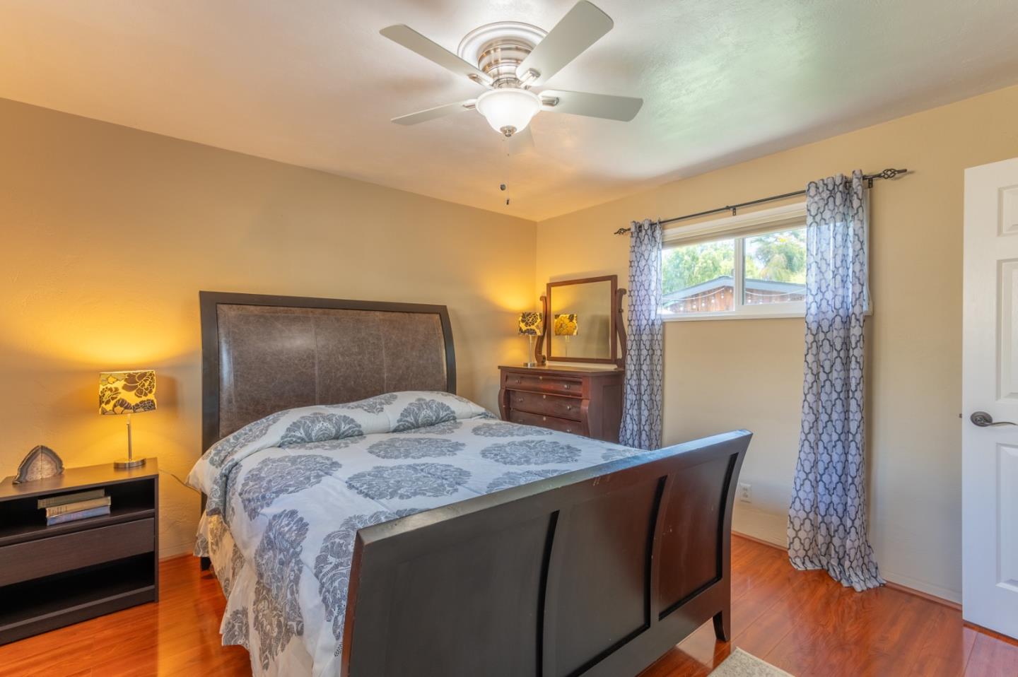2 Merrill Way Carmel Valley, CA 93924 - Photo 22 of 43 a bedroom with a bed and a chandelier