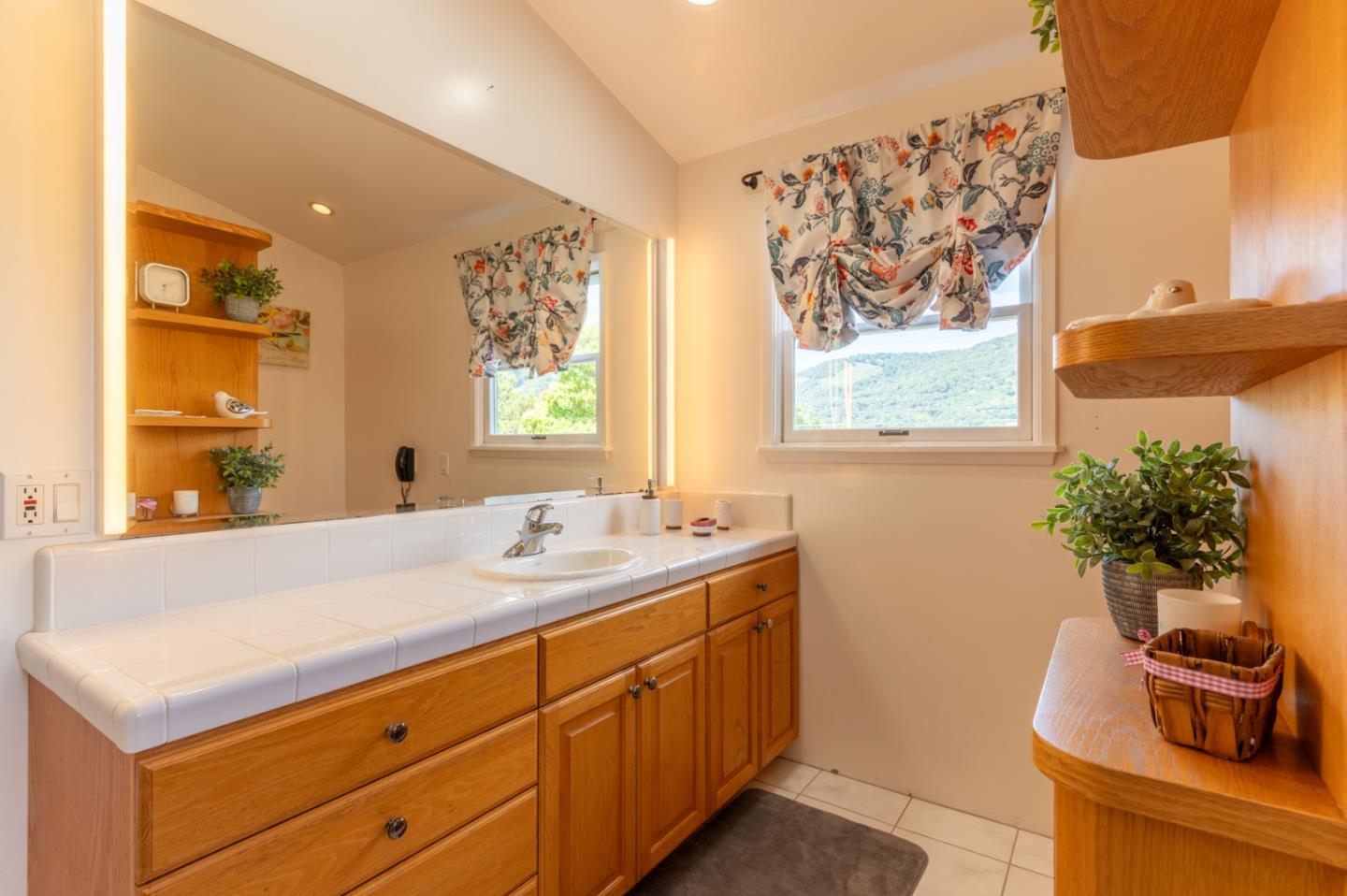 2 Merrill Way Carmel Valley, CA 93924 - Photo 6 of 43 a bathroom with a sink a large mirror and a window