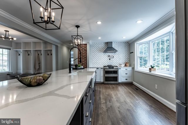 a front view of a house with a yard and green space