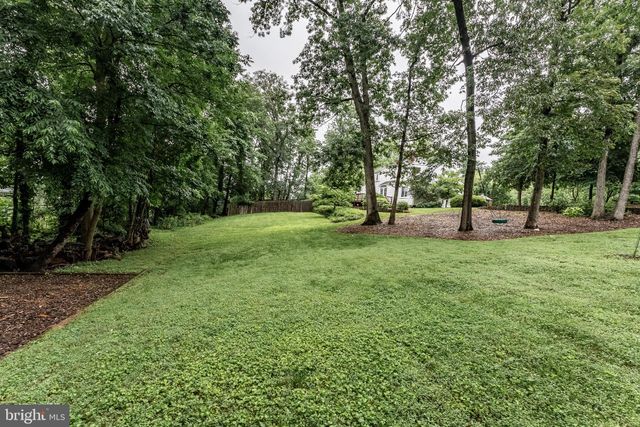 a spacious bathroom with a granite countertop sink mirror and window