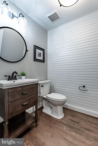 a living room with furniture a wooden floor and a fireplace