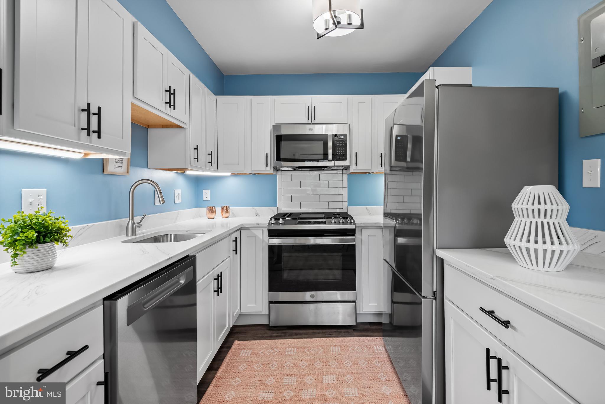 95 East Wayne Avenue, Unit 404 Silver Spring, MD 20901 - Photo 12 of 25 a kitchen with granite countertop a sink stove and refrigerator