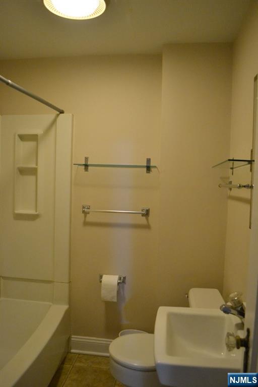 192 West Midland Avenue, Unit 1 Paramus, NJ 07652 - Photo 13 of 14 a bathroom with a sink a toilet and shower