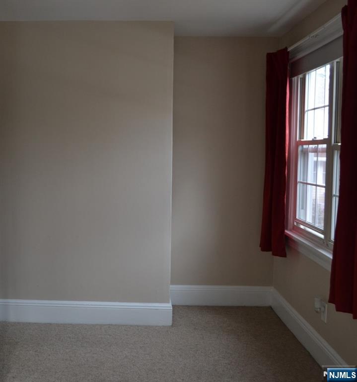 192 West Midland Avenue, Unit 1 Paramus, NJ 07652 - Photo 5 of 14 a view of an empty room with a window