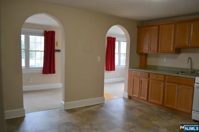 an empty room with wooden floor and cabinet