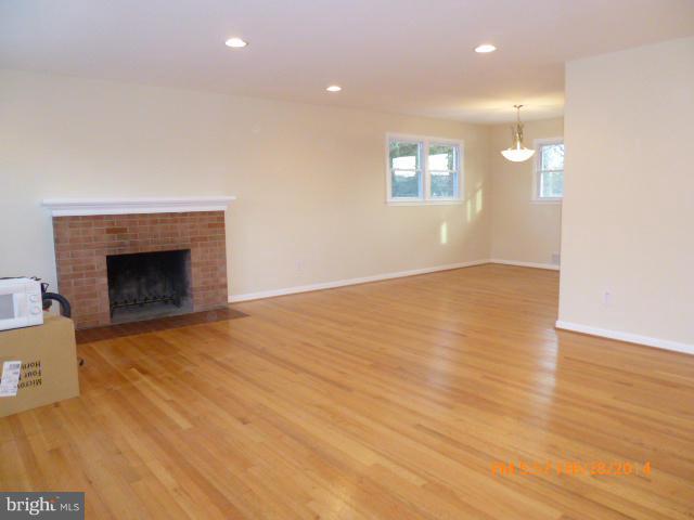 7935 Ellet Road Springfield, VA 22151 - Photo 3 of 30 a view of an empty room with wooden floor and a fireplace