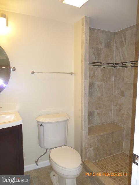 7935 Ellet Road Springfield, VA 22151 - Photo 22 of 30 a white toilet sitting next to a bathroom sink