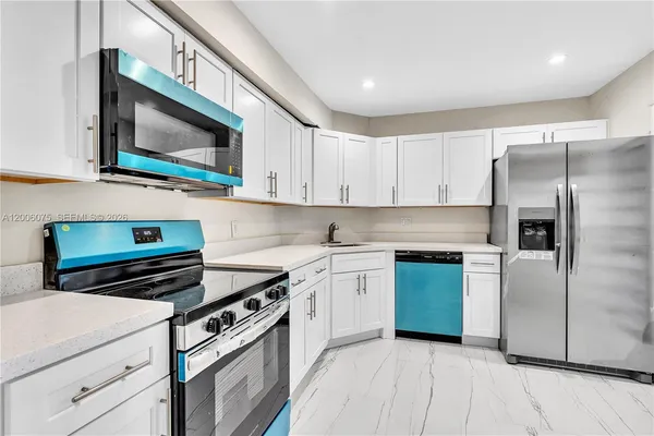 a kitchen with a stove microwave and sink