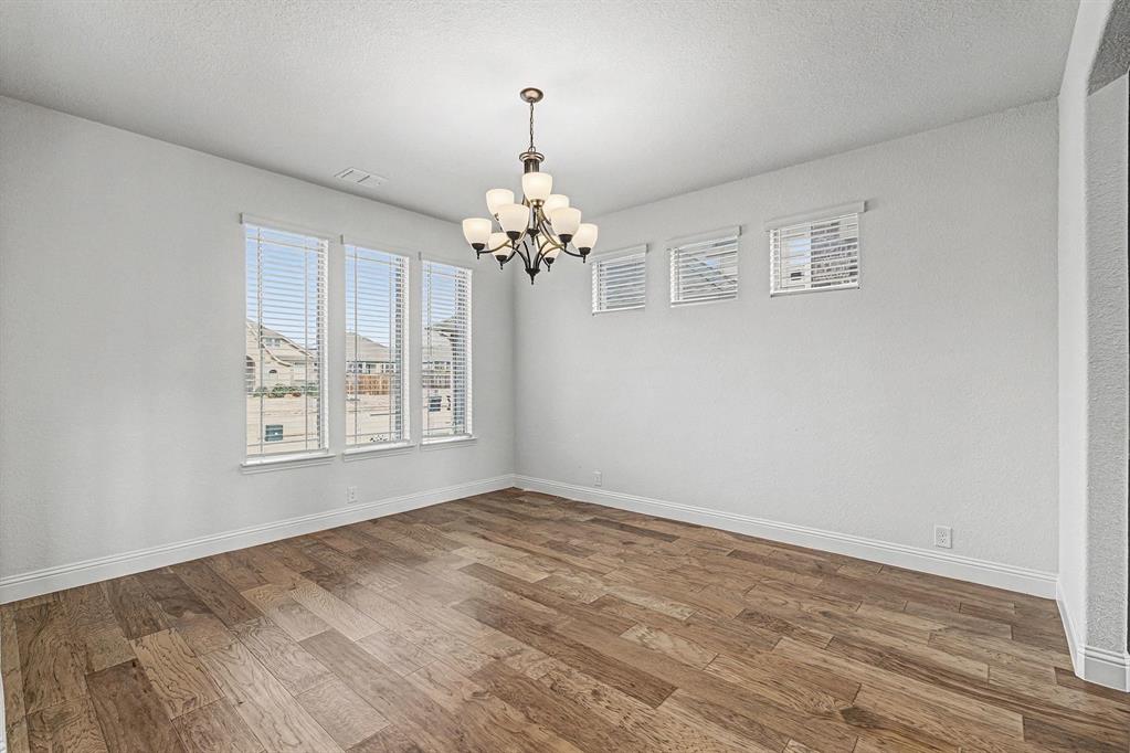 1080 Canuela Way Justin, TX 76247 - Photo 12 of 40 wooden floor in an empty room with a window