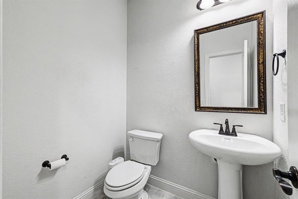 1080 Canuela Way Justin, TX 76247 - Photo 15 of 40 a bathroom with a toilet sink and mirror