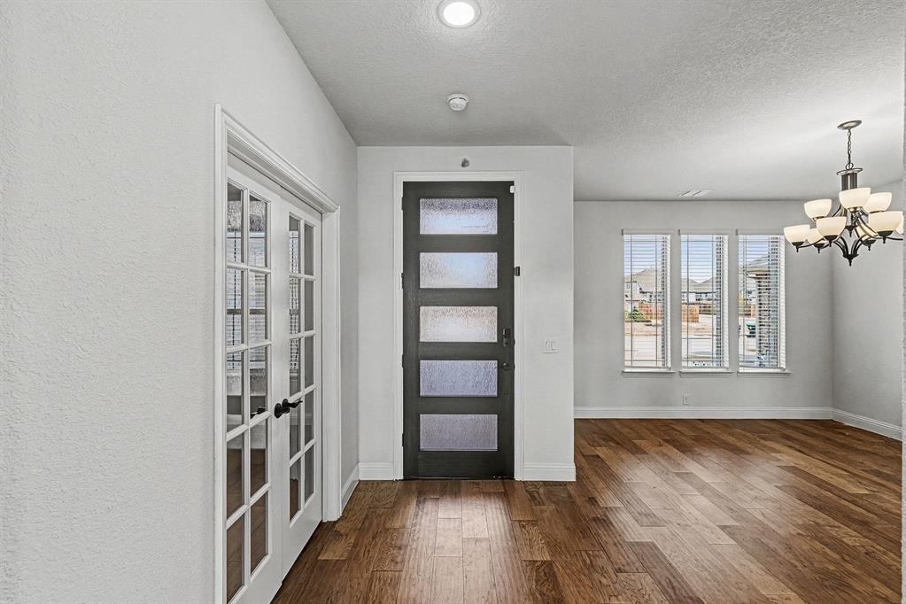 1080 Canuela Way Justin, TX 76247 - Photo 7 of 40 wooden floor in an empty room with a window