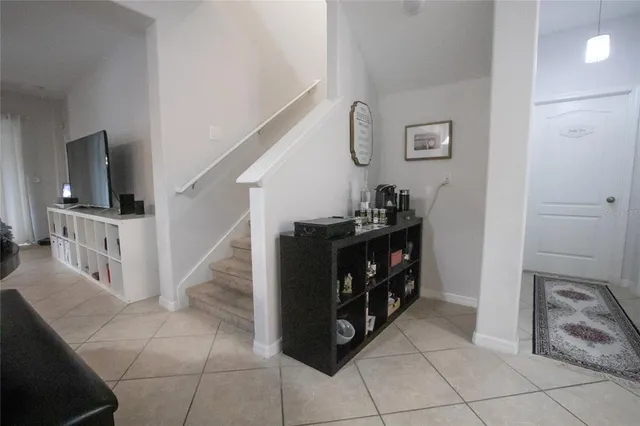 a kitchen with a dining table chairs and refrigerator