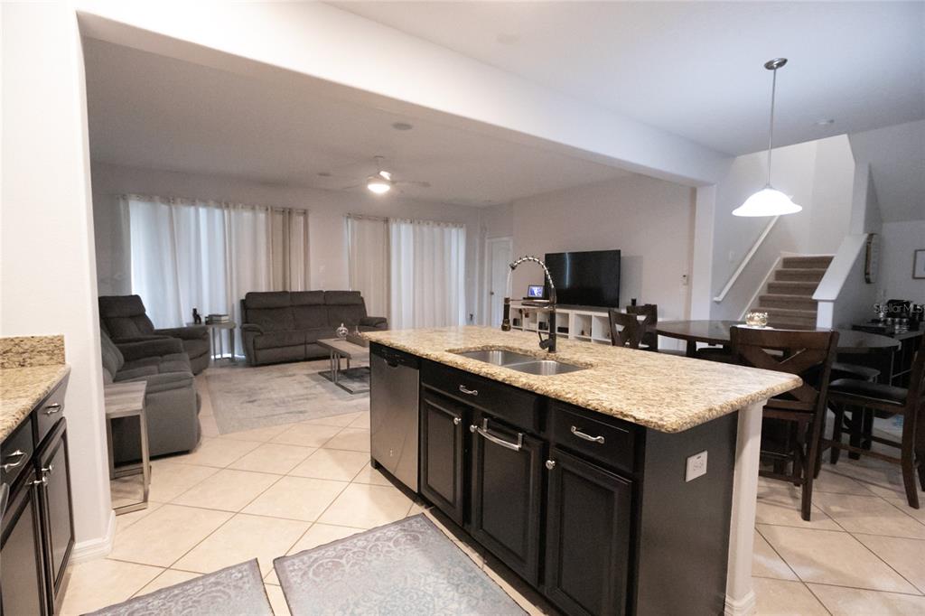 1185 Seburn Road Apopka, FL 32703 - Photo 16 of 47 a kitchen with a sink a counter top space appliances and cabinets